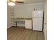 Room interior with desk, shelving and refrigerator with grey walls and vinyl floors at 1160 Rolling Acres Dr, Deland, FL 32720