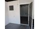 View from room to room showing the white walls, grey floor, ceiling fan and window air conditioning unit at 1160 Rolling Acres Dr, Deland, FL 32720