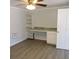 Room interior with built-in desk and shelving, grey walls and vinyl floors at 1160 Rolling Acres Dr, Deland, FL 32720