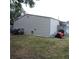 View of the property's shed with riding mower, and other lawn equipment, on the property at 1160 Rolling Acres Dr, Deland, FL 32720
