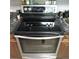 Featuring a stainless steel stove with a sleek glass top, surrounded by dark granite countertops at 1160 Rolling Acres Dr, Deland, FL 32720