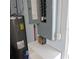 Utility room featuring a water heater and open electrical box at 1160 Rolling Acres Dr, Deland, FL 32720