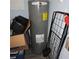 Efficient RHEEM water heater situated next to a black steel cart in the basement utility room at 1160 Rolling Acres Dr, Deland, FL 32720
