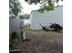 An expansive yard features a shed, and a trailer parked next to a fence at 1160 Rolling Acres Dr, Deland, FL 32720