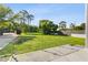 View of the spacious backyard from the patio, surrounded by lush green grass and mature trees at 11734 Lake Willis Dr, Orlando, FL 32821