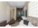 Modern bathroom features a walk-in shower, a large soaking tub, double sinks and a glass block window at 11734 Lake Willis Dr, Orlando, FL 32821