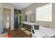 Bathroom featuring double sinks, a walk-in shower and jacuzzi tub at 11734 Lake Willis Dr, Orlando, FL 32821