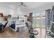 bedroom with bunk bed, study area, toys, ceiling fan and light floors at 11734 Lake Willis Dr, Orlando, FL 32821