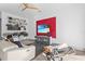 Modern den space with a red wave-textured accent wall and built in shelves above a large white sofa at 11734 Lake Willis Dr, Orlando, FL 32821