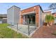 Modern architecture with glass railing patio, wood paneling, metal accents, and landscaping at 11734 Lake Willis Dr, Orlando, FL 32821