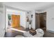 Bright foyer with modern finishes, featuring a unique door, white walls and wood look floors at 11734 Lake Willis Dr, Orlando, FL 32821