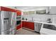 Modern kitchen featuring stainless steel appliances and red cabinetry at 11734 Lake Willis Dr, Orlando, FL 32821