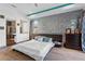 Tranquil main bedroom with a textured headboard wall and an en-suite bathroom with glass shower at 11734 Lake Willis Dr, Orlando, FL 32821