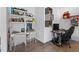Office area with modern grey accent walls, a white desk and chair, plus storage for books and decor at 11734 Lake Willis Dr, Orlando, FL 32821