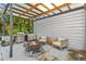 Outdoor kitchen area with grill, sink, and seating, perfect for entertaining in any weather at 11734 Lake Willis Dr, Orlando, FL 32821