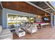 Relaxing outdoor patio featuring a pool table, lounge furniture, and scenic waterfront views at 11734 Lake Willis Dr, Orlando, FL 32821