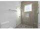 Modern tiled glass shower with a rainfall shower head and built-in niche at 11734 Lake Willis Dr, Orlando, FL 32821
