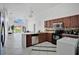 Well-lit kitchen featuring tile floors, breakfast bar, and modern appliances at 119 Hypolita Ave, Davenport, FL 33897