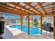 Outdoor covered lounge area next to a screened pool, ideal for entertaining and relaxation at 119 Hypolita Ave, Davenport, FL 33897