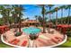 Community pool featuring tall palm trees, seating, and cabanas for a resort-style experience at 119 Hypolita Ave, Davenport, FL 33897