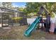Backyard with a playset and a screened-in pool area at 121 Edgewater Cir, Sanford, FL 32773