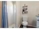 Bathroom shower and toilet alongside shelving at 121 Edgewater Cir, Sanford, FL 32773