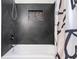Modern bathroom with sleek black tile and a shower at 121 Edgewater Cir, Sanford, FL 32773