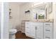 Bright bathroom features a white vanity with granite counters and modern fixtures at 121 Edgewater Cir, Sanford, FL 32773