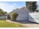 Exterior view of home with garage, lawn, front door, and a portable storage unit in the driveway at 121 Edgewater Cir, Sanford, FL 32773