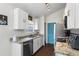 Well-lit kitchen features white cabinets, granite countertops, stainless steel appliances, and contrasting blue door at 121 Edgewater Cir, Sanford, FL 32773