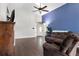 Inviting living room with a blue accent wall, hardwood floors and a ceiling fan at 121 Edgewater Cir, Sanford, FL 32773