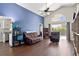 Spacious living room featuring vaulted ceilings, hardwood floors, large windows, and a cozy seating area at 121 Edgewater Cir, Sanford, FL 32773