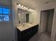 Bathroom with double sinks, modern lighting, and glass shower at 1243 Bear Oak Ln, Deland, FL 32720