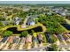 Aerial view of home nestled in a lush community with ponds and mature trees at 12817 Parkbury Dr, Orlando, FL 32828
