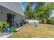 Spacious backyard with a patio, a swing set, and a white picket fence at 12817 Parkbury Dr, Orlando, FL 32828
