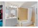 Bathroom featuring tiled walls, bathtub, and storage shelves at 12817 Parkbury Dr, Orlando, FL 32828