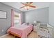 Bedroom featuring tile flooring, a ceiling fan, and a crib at 12817 Parkbury Dr, Orlando, FL 32828