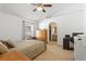 Bedroom features tile flooring, a ceiling fan, a closet, and an attached bathroom at 12817 Parkbury Dr, Orlando, FL 32828