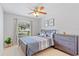Cozy bedroom featuring tile flooring, a window view, and a comfortable bed at 12817 Parkbury Dr, Orlando, FL 32828
