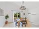 Eat-in kitchen area with tile floors, light fixture, and sliding glass doors to the backyard at 12817 Parkbury Dr, Orlando, FL 32828