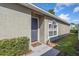 Inviting front entry with a gray door, manicured bushes, and a tiled entryway at 12817 Parkbury Dr, Orlando, FL 32828