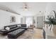 Cozy living room features tile floors, a plush leather couch, and neutral walls at 12817 Parkbury Dr, Orlando, FL 32828