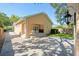 Rear exterior view of stucco home showcasing outdoor patio and lush backyard at 1333 W Yale St, Orlando, FL 32804