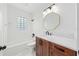 Bright bathroom featuring marble countertop vanity, stylish fixtures, and a tub with decorative block window at 1333 W Yale St, Orlando, FL 32804