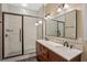 Bathroom boasts a double sink vanity with a marble countertop and a glass-enclosed tiled shower at 1333 W Yale St, Orlando, FL 32804