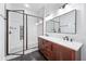 Modern bathroom featuring a glass shower enclosure, double vanity with marble countertop, and stylish fixtures at 1333 W Yale St, Orlando, FL 32804