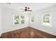 Bright bedroom with hardwood floors, ceiling fan, and two windows offering abundant natural light at 1333 W Yale St, Orlando, FL 32804
