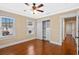 Bright bedroom features hardwood floors, closet with drawers, baseboard trim, and ample natural light at 1333 W Yale St, Orlando, FL 32804