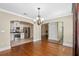 Dining room leading to kitchen, featuring hardwood floors, chandelier, and views to other rooms at 1333 W Yale St, Orlando, FL 32804