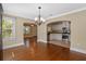 Dining room leading to kitchen, featuring hardwood floors, chandelier, and views to other rooms at 1333 W Yale St, Orlando, FL 32804